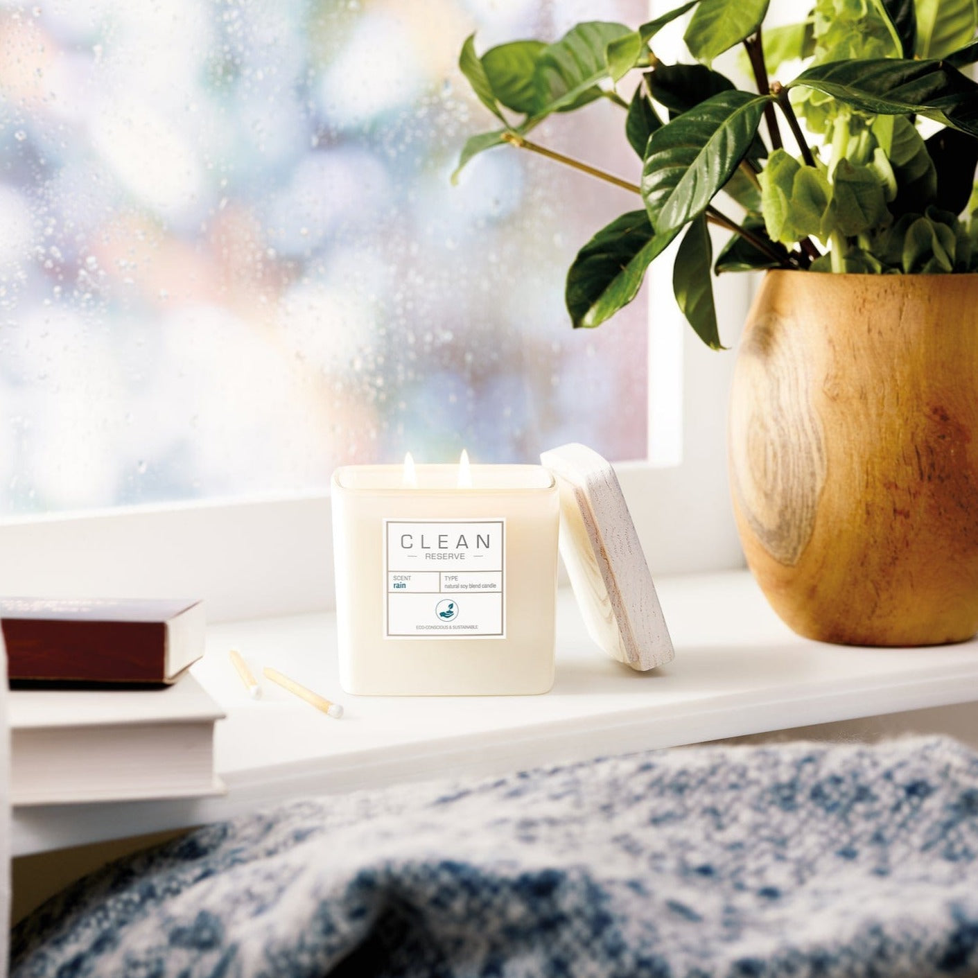 Clean Reserve Rain Natural Soy Blend Candle in window